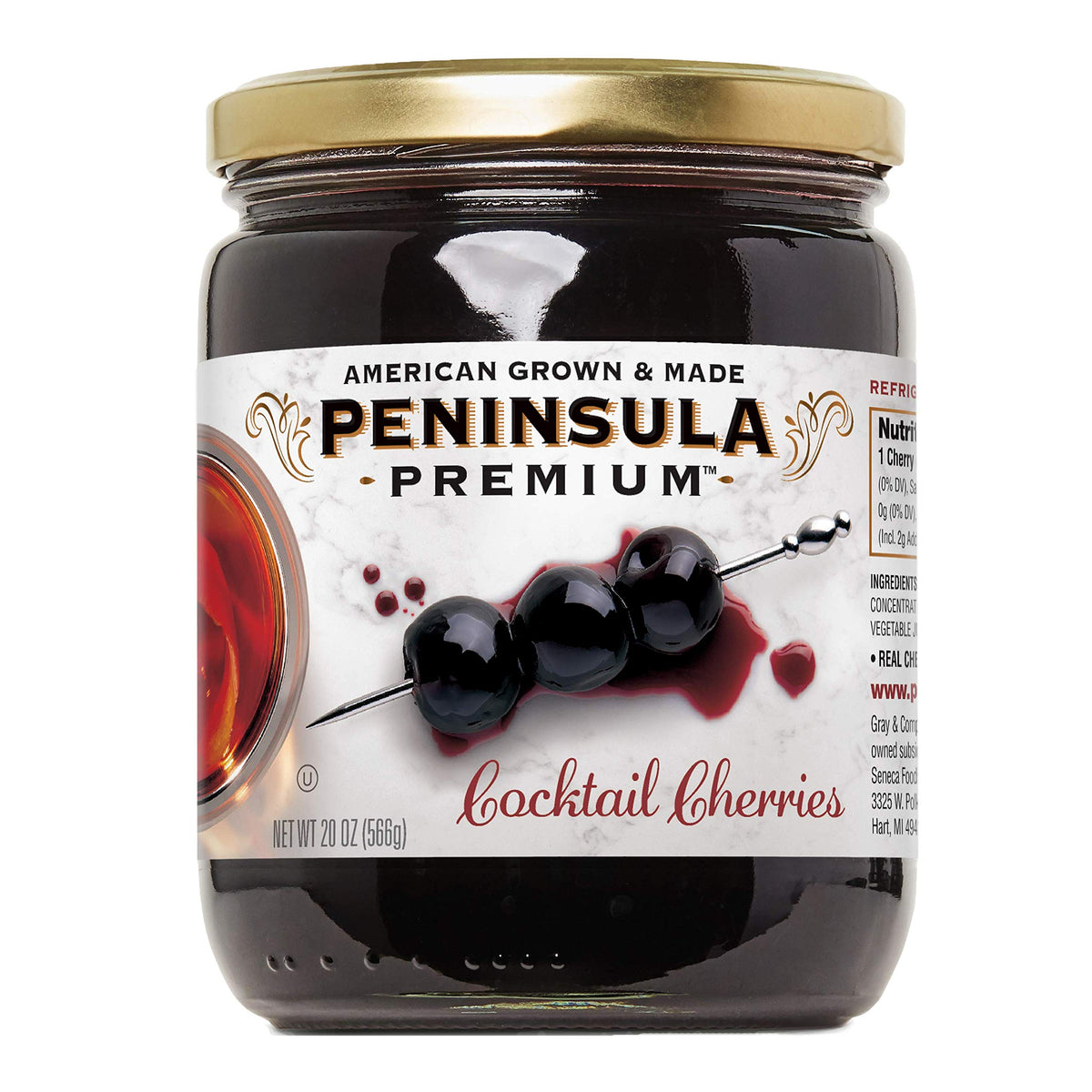 Peninsula Premium cocktail cherries in a deep burgundy glass serve as a luxurious cocktail garnish.