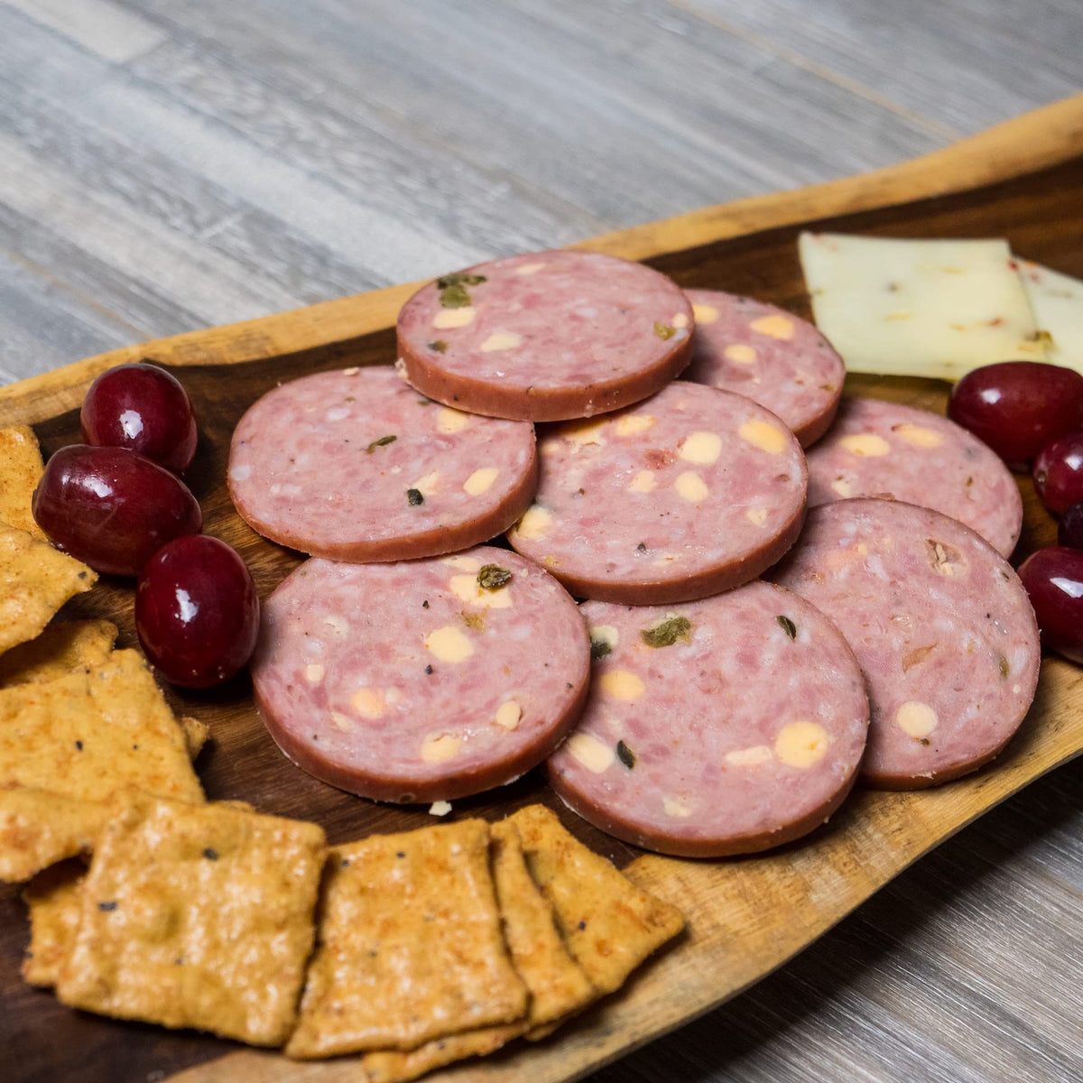 Pepper Joe's Jalapeno Cheddar Summer Sausage on a charcuterie board, party-ready.