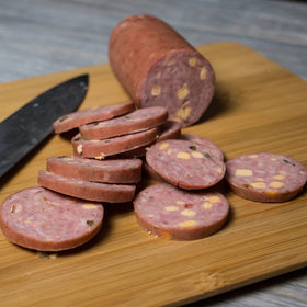Pepper Joe's Jalapeno Cheddar Summer Sausage smoked log shows rich aroma.