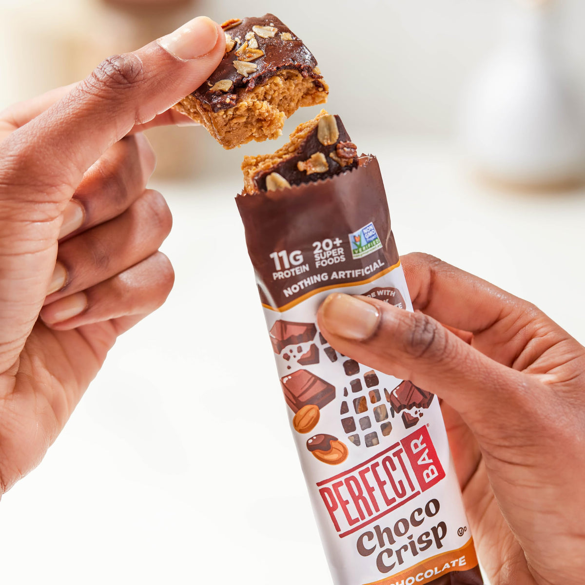 Perfect Bar Choco Crisp cashew and organic peanut butter layer close-up.