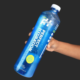 Ideal for workouts, Perfect Hydration 9.5+ pH bottle on a gym bag.
