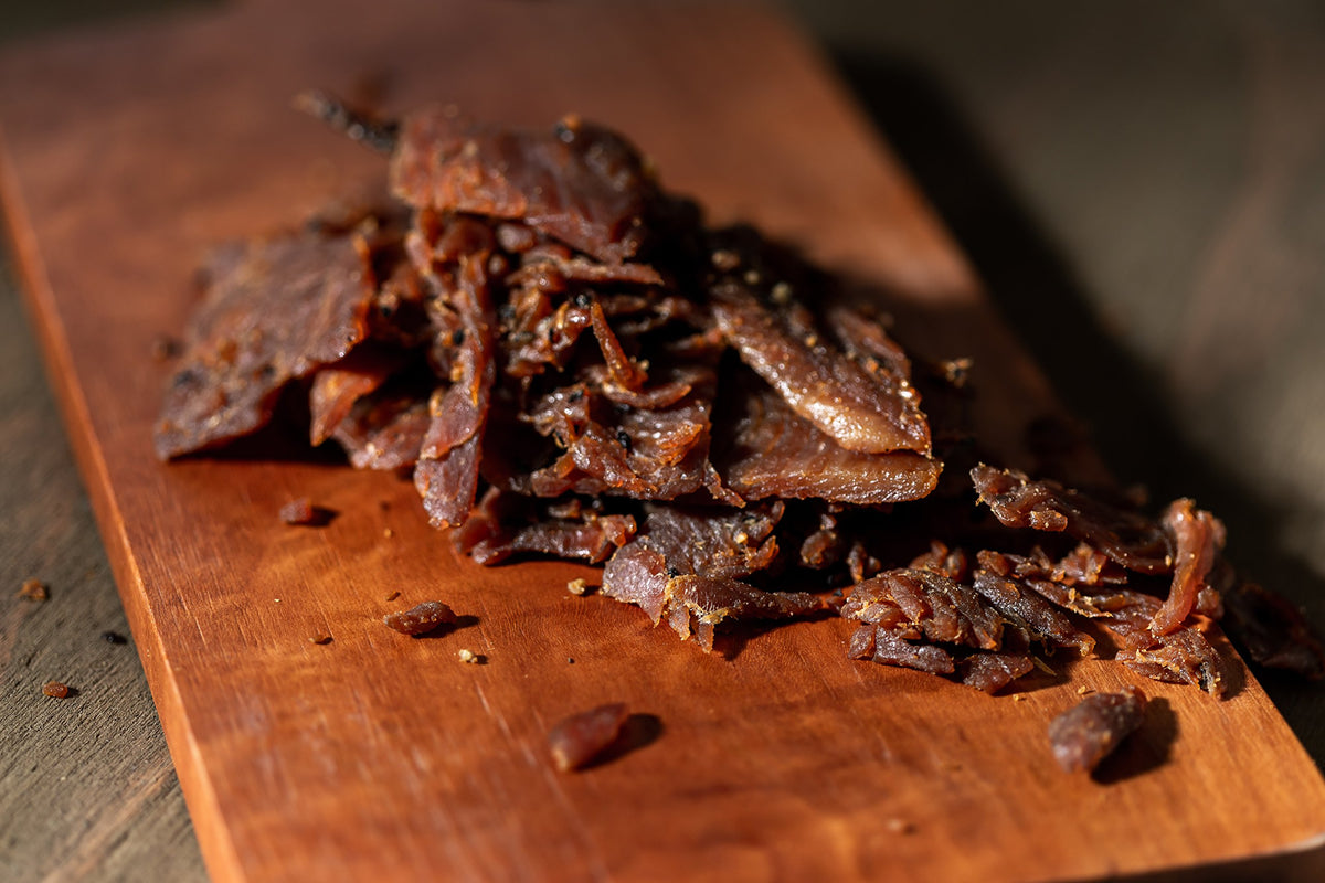 Perky Jerky turkey slices marinated with peppers and garlic, close-up texture.