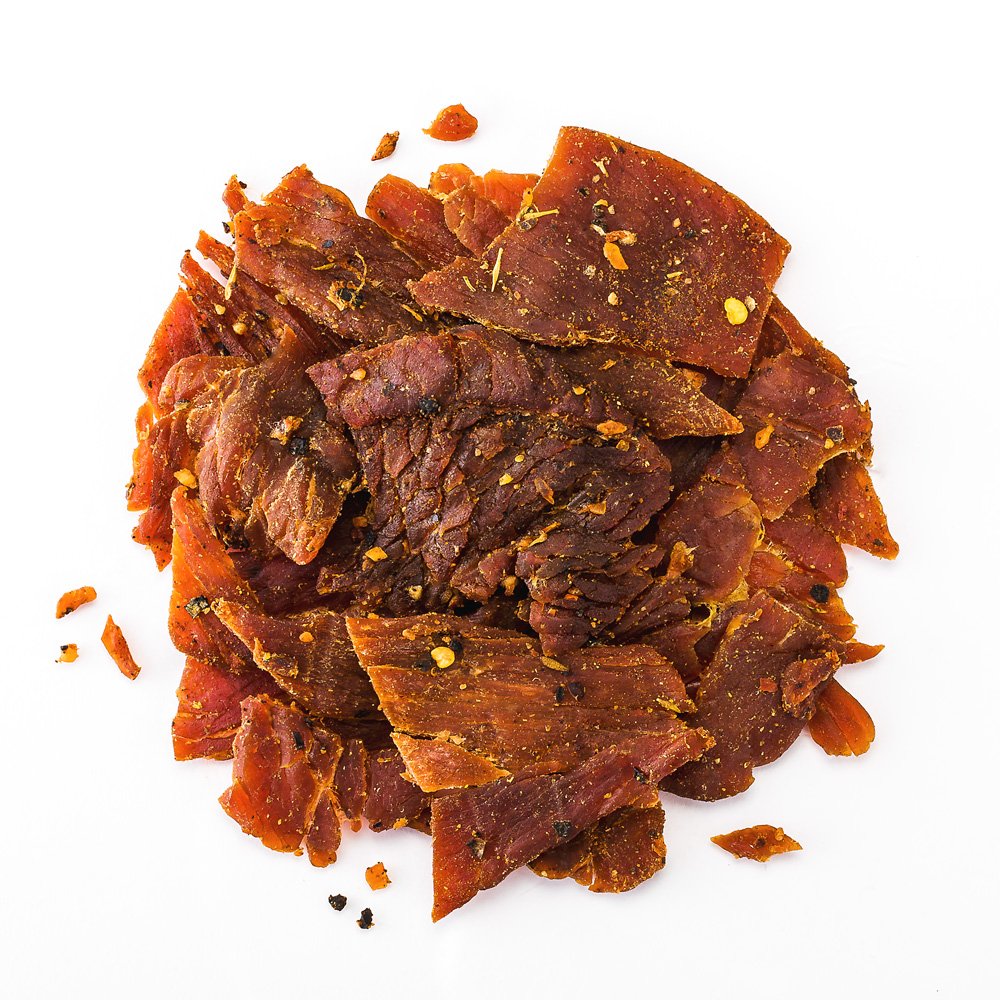 Perky Jerky Jammin' Jamaican turkey jerky close-up texture shows melt-in-your-mouth tenderness.