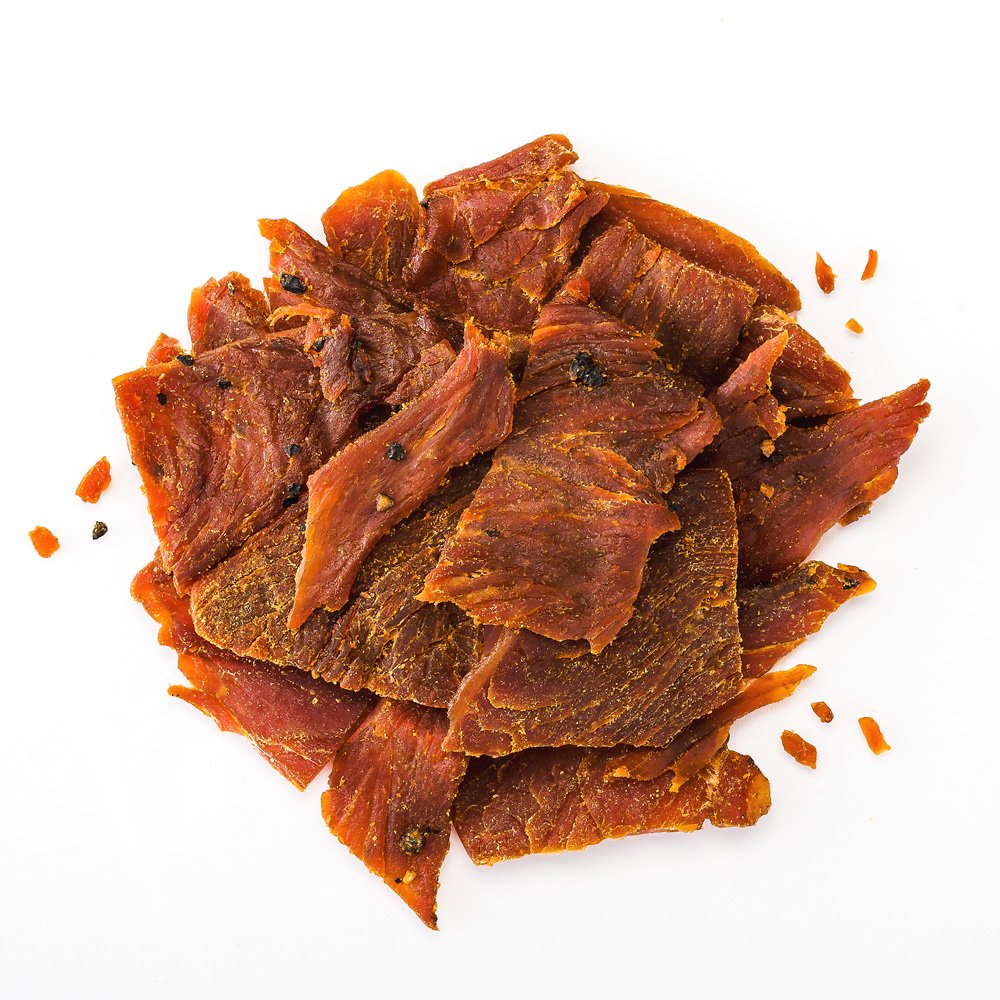 Perky Jerky turkey jerky slices marinated for tender texture and rich taste.