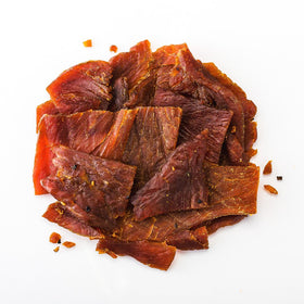 Sliced turkey jerky close-up reveals tender, glossy teriyaki glaze.
