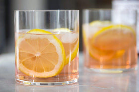 Peychaud's Aromatic Bitters being poured to enhance flavor profiles.