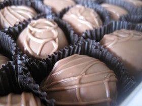 Philadelphia Candies maple cream detail on a glossy milk chocolate shell.