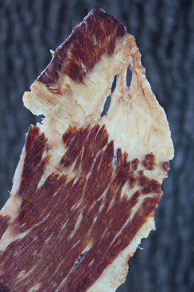 PHILLIPS BEEF CRISPS Beef Brisket texture closeup emphasizing crackling bite.