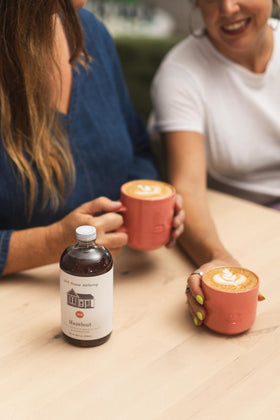 Pink House Alchemy Hazelnut Simple Syrup latte drink elevates café-quality beverages at home.