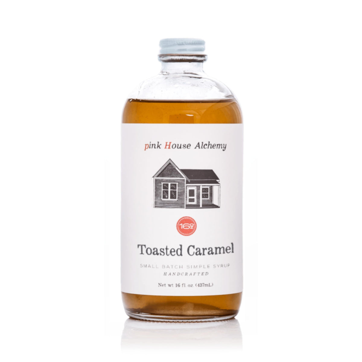 Pink House Alchemy toasted caramel syrup bottle pour enhances coffee and cocktails.