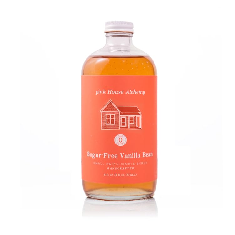Pink House Alchemy Vanilla Bean Syrup bottle pour enhances coffee with sugar-free vanilla flavor.