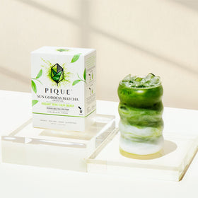 Close-up of PIQUE Sun Goddess Matcha powder showing vibrant green texture