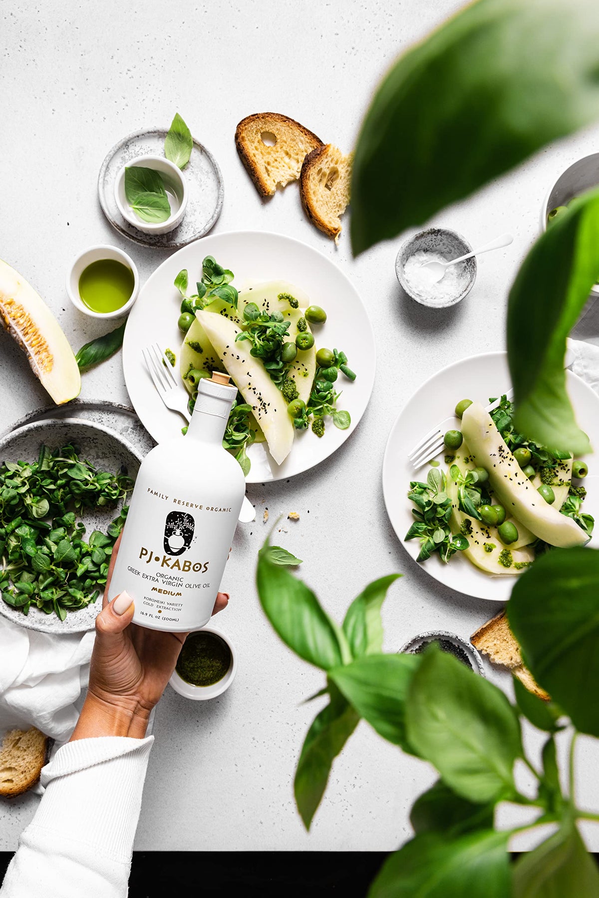 P.J. KABOS non-GMO olive oil bottle highlights versatile cooking potential.