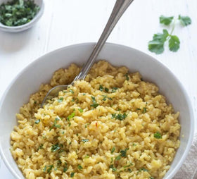 Planet Rice bulk scoop measuring sprouted brown rice for easy portions.