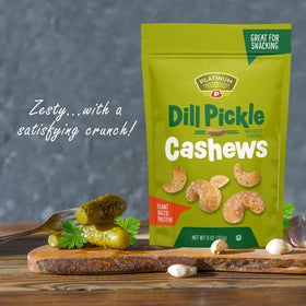 Platinum Dill Pickle Cashews in hand, portable protein snack.