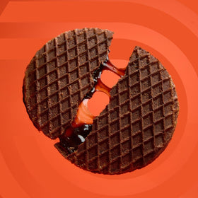 Podium Protein Stroopwafel chocolate brownie held in hand, tasty fuel between sets