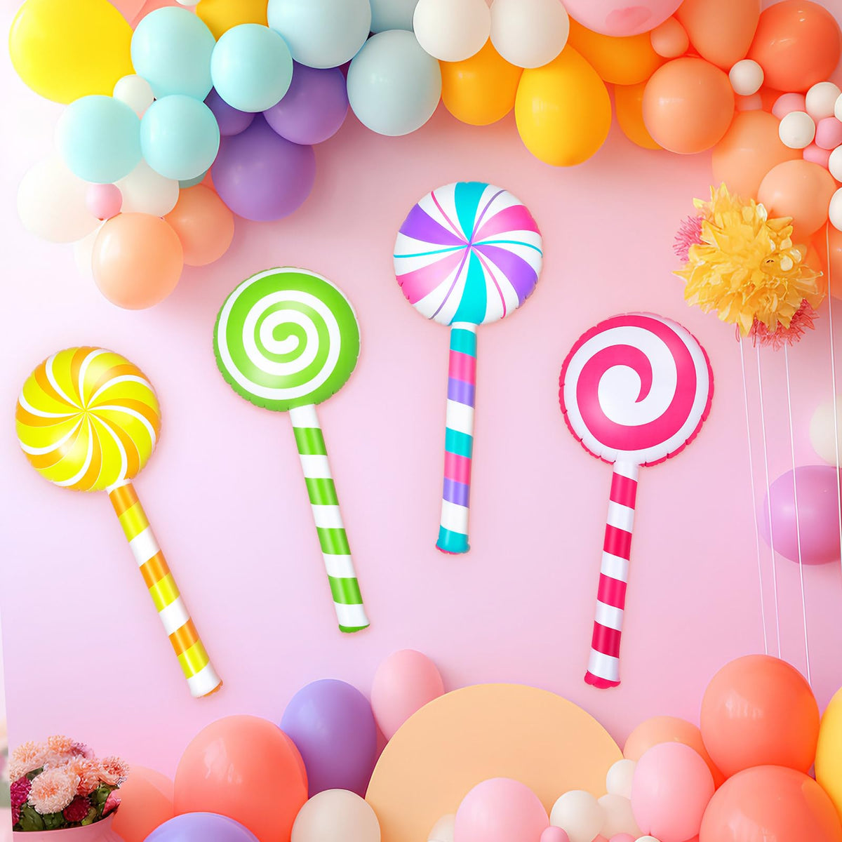 Poen green inflatable lollipop prop creates a playful candy atmosphere.