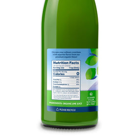 Polengi organic lime juice splashing into a glass with ice.