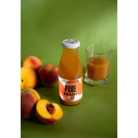 Pomona Organic Peach Juice glass served with peaches: great addition to smoothies and sparkling drinks.