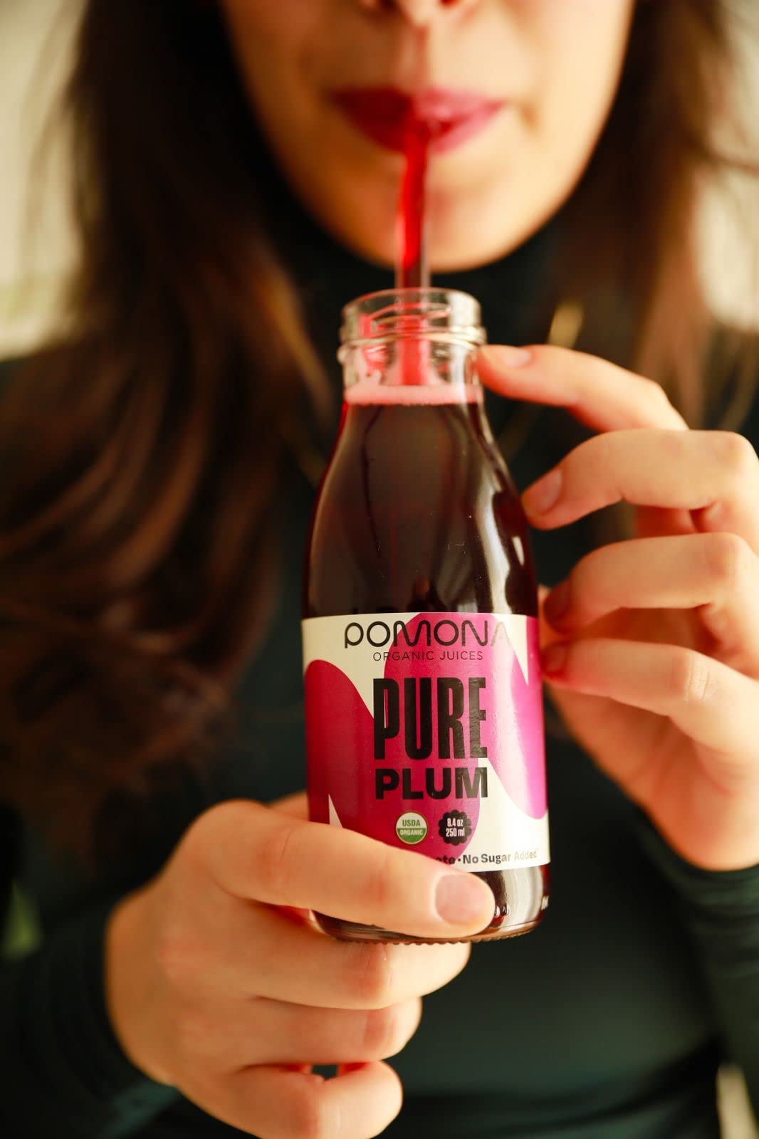 Pomona Organic Plum Juice pour into glass demonstrates ready-to-drink versatility