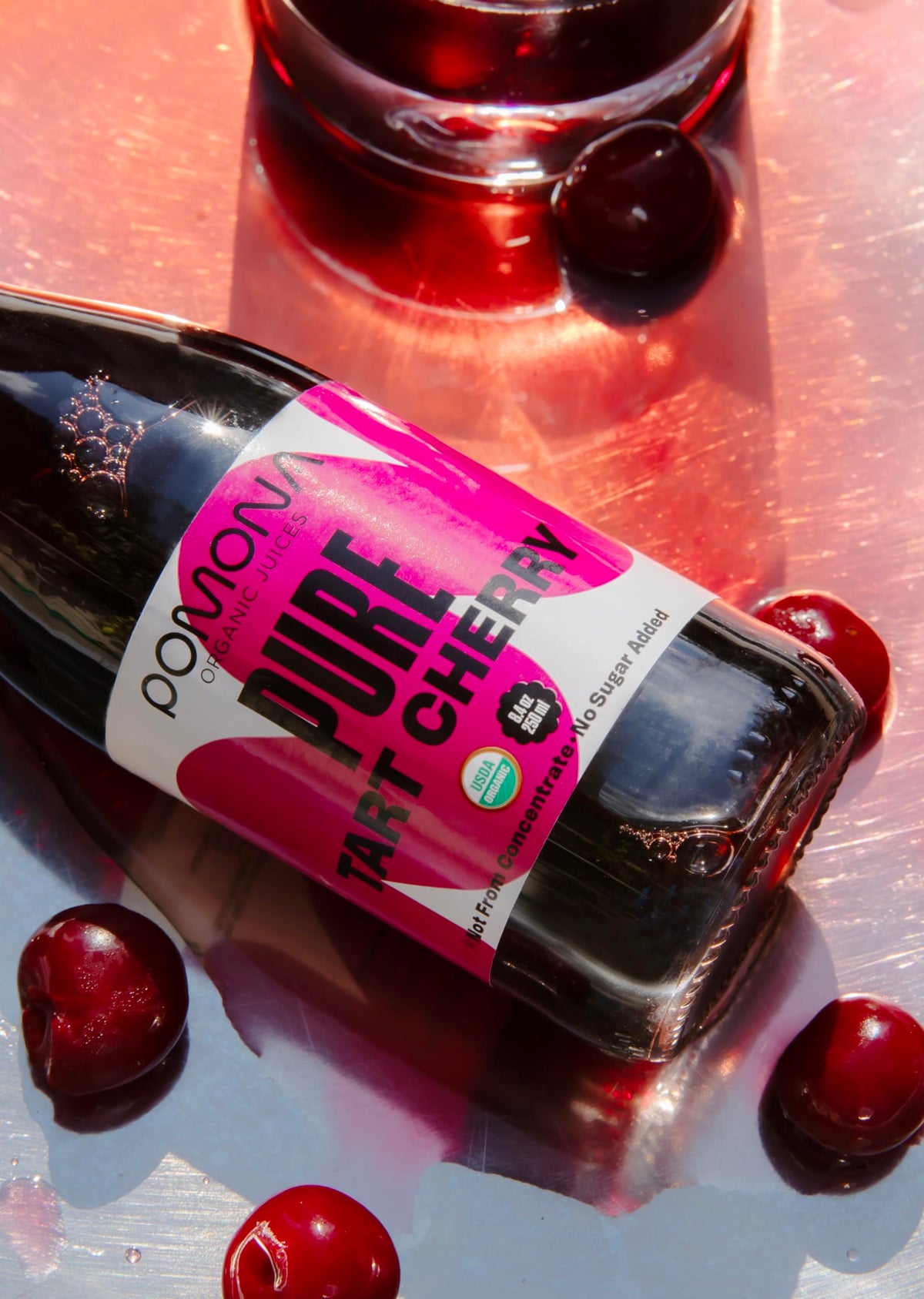 Pomona Organic Tart Cherry Juice 12-pack in glass bottles; eco-friendly, preservative-free.