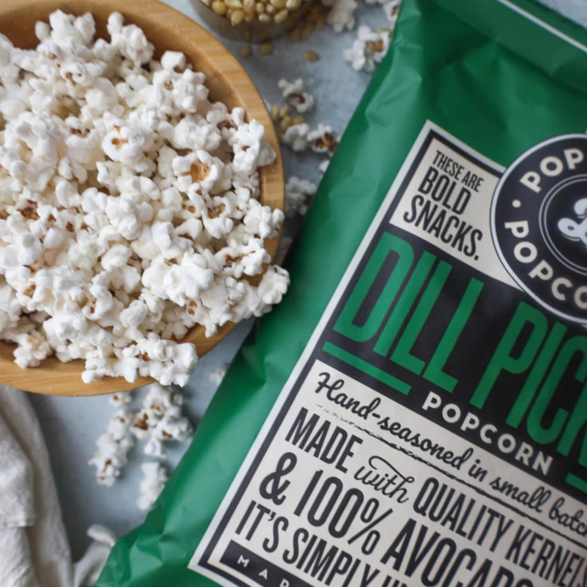 POP DADDY Dill Pickle popcorn poured into bowl with bold aroma.