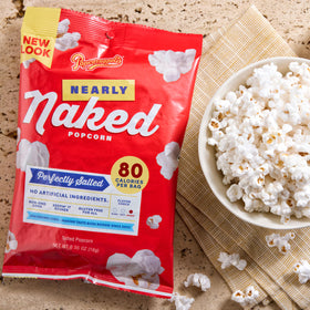 Non-GMO emblem on Popcornopolis Nearly Naked packaging emphasizes quality