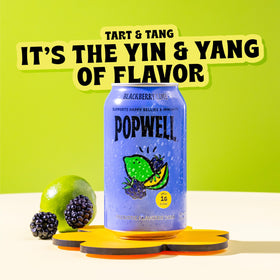 Popwell Blackberry Lime can on a picnic table, ideal outdoor refreshment.