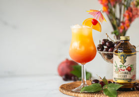 Portland Syrups Pomegranate Cherry mocktail in a tall glass.