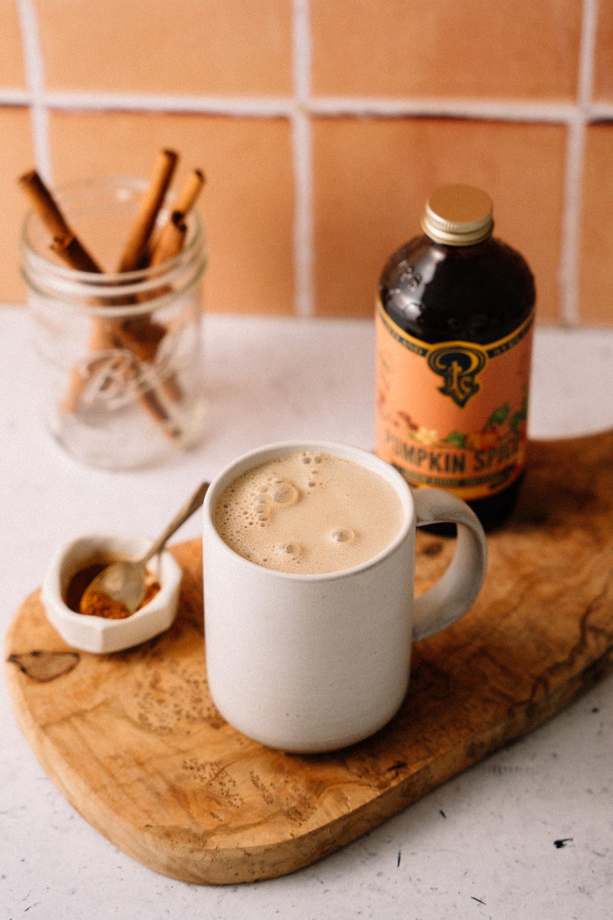 Portland Syrups Pumpkin Spice Syrup being poured to flavor coffee and desserts.