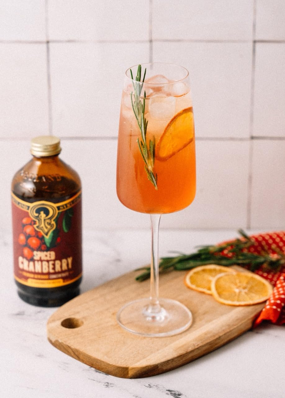Portland Syrups Spiced Cranberry Syrup on a holiday table with spices and berries