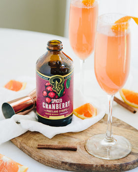 Portland Syrups Spiced Cranberry Syrup pouring into a glass for versatile drinks