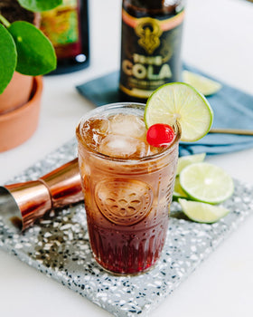 Pour scene with True Cola and lime for a lighter, refreshing soda option.