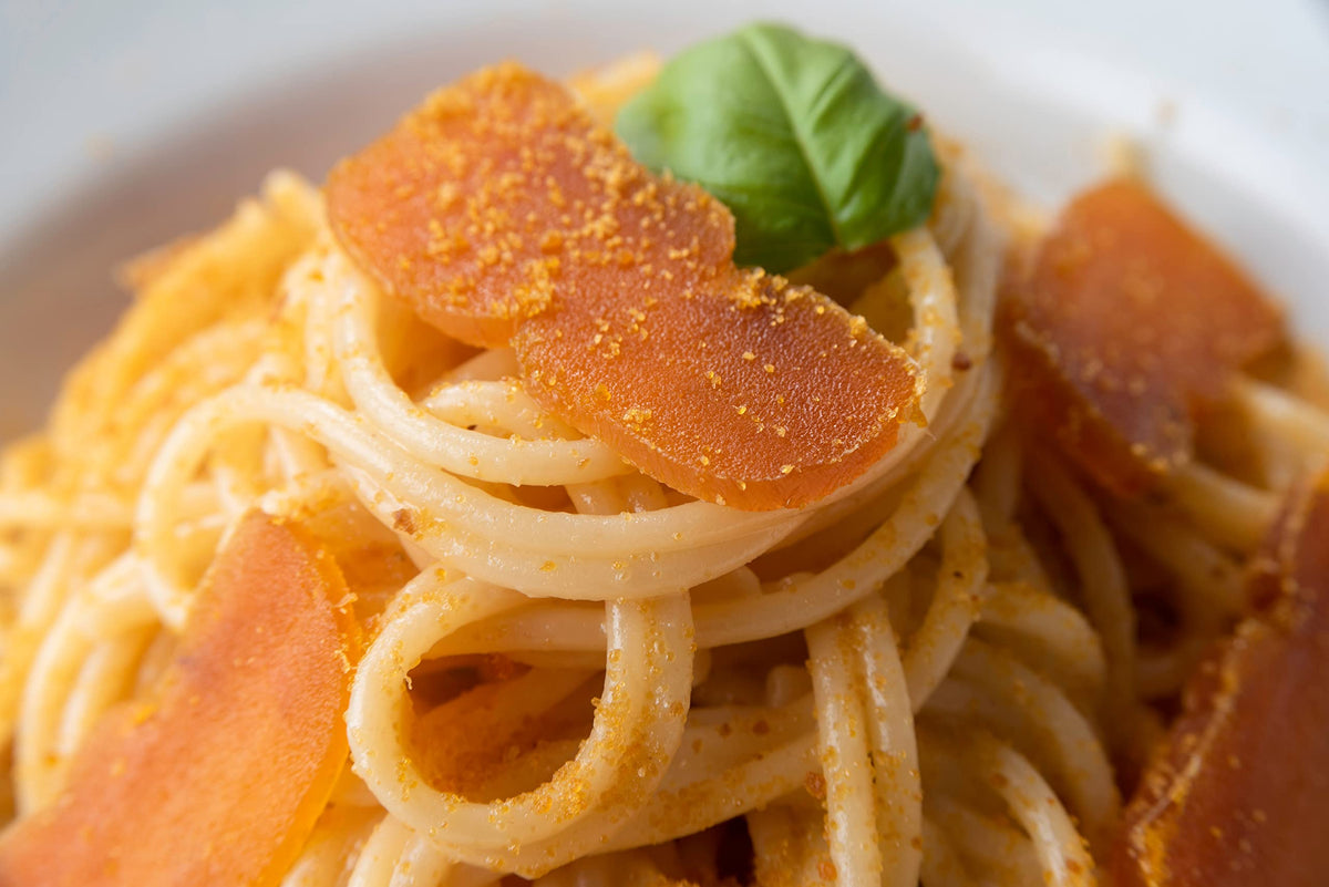 Poseidon Bottarga on charred bread creates a bold, gourmet bite.