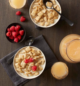 Bowl of Post Spoon Size Shredded Wheat with berries for fiber.