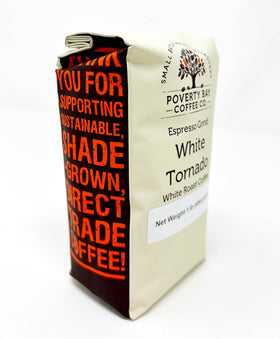 Cup of White Tornado coffee with creamer, illustrating versatile flavor pairing.