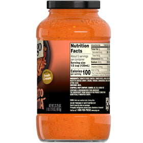 Prego Creamy Tomato Ricotta sauce bottle on table during family dinner.