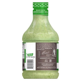 Salad bowl with Primal Kitchen dressing as a tangy finishing touch