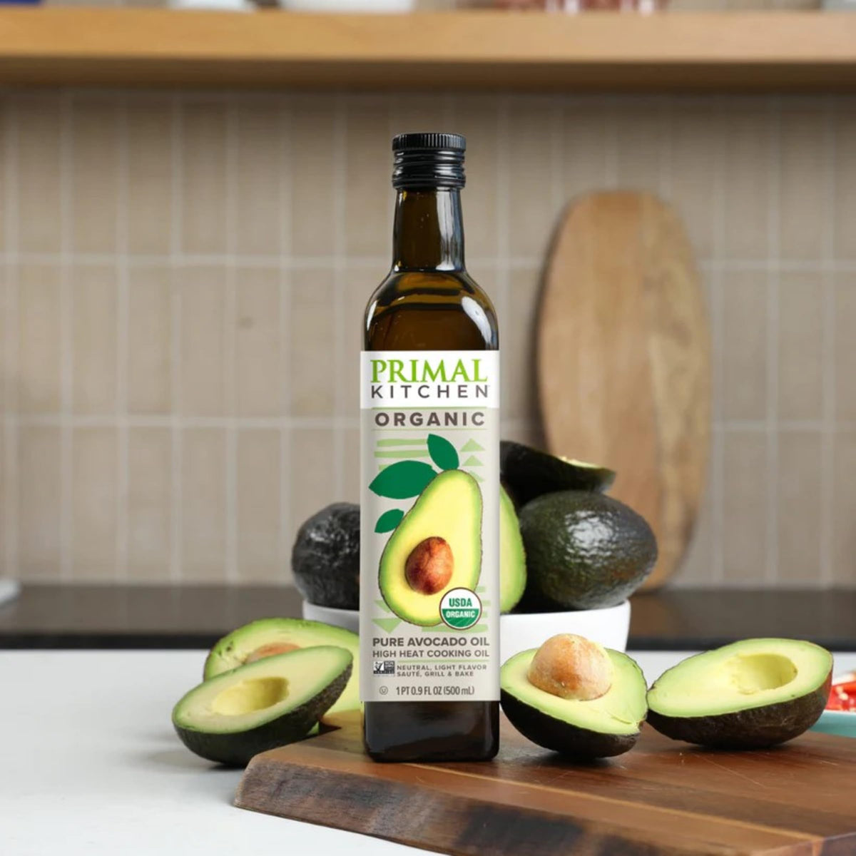 Primal Kitchen Avocado Oil 500ml bottle on counter ready for cooking and finishing touches.
