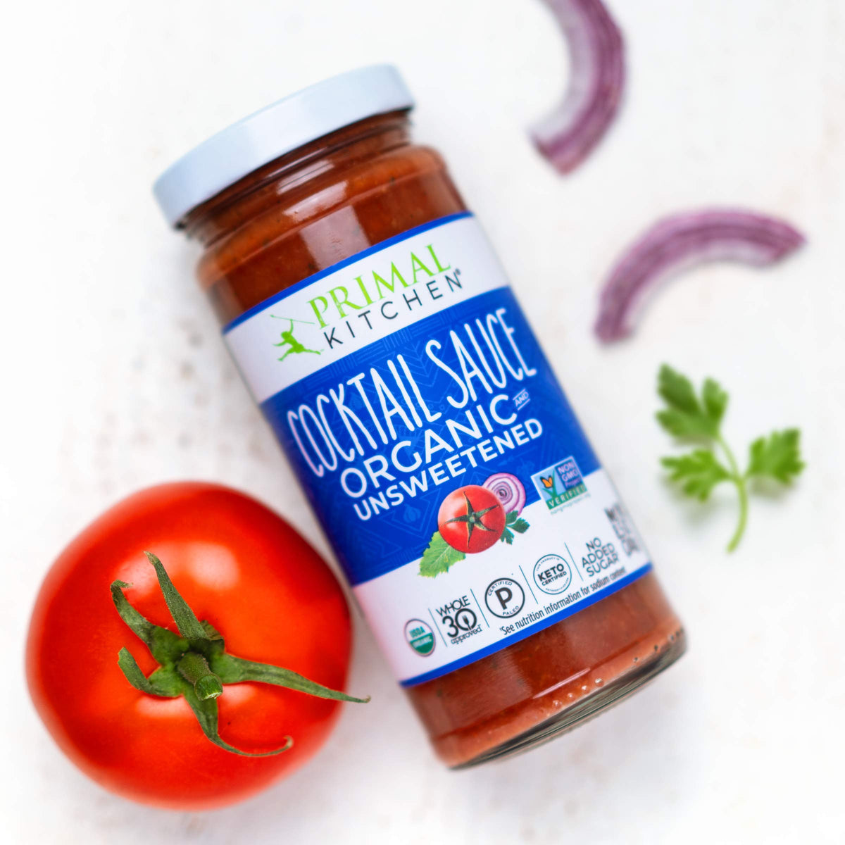 Primal Kitchen Organic Cocktail Sauce bottle beside shrimp ring for dipping