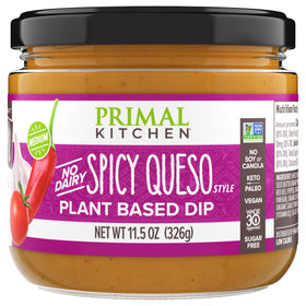 Primal Kitchen Dip Queso Spicy bottle pour shows creamy, dairy-free queso for dipping.