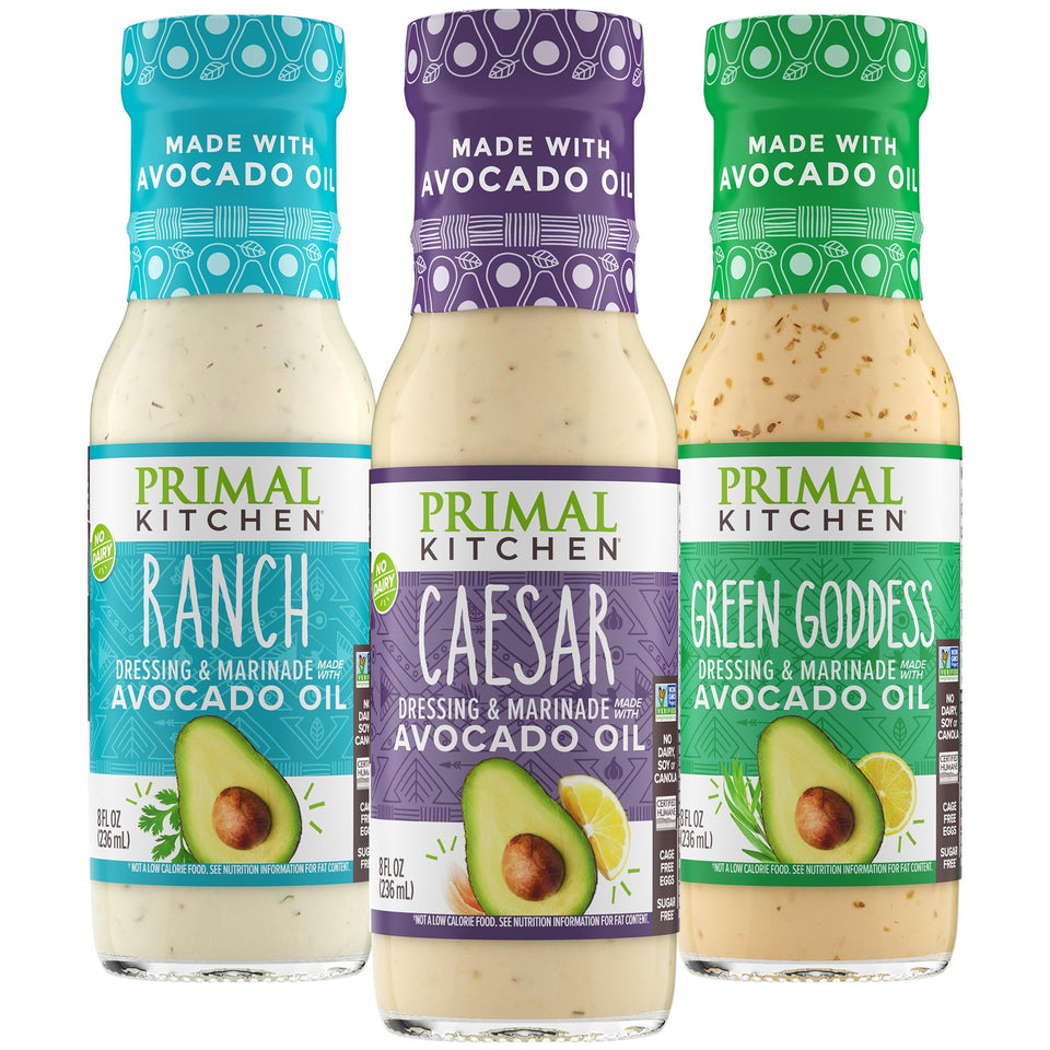 Primal Kitchen Ranch dressing bottle pour, creamy texture ideal for salads and toppings.