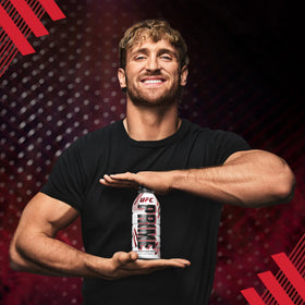 Hands holding PRIME Hydration UFC bottle during cool down