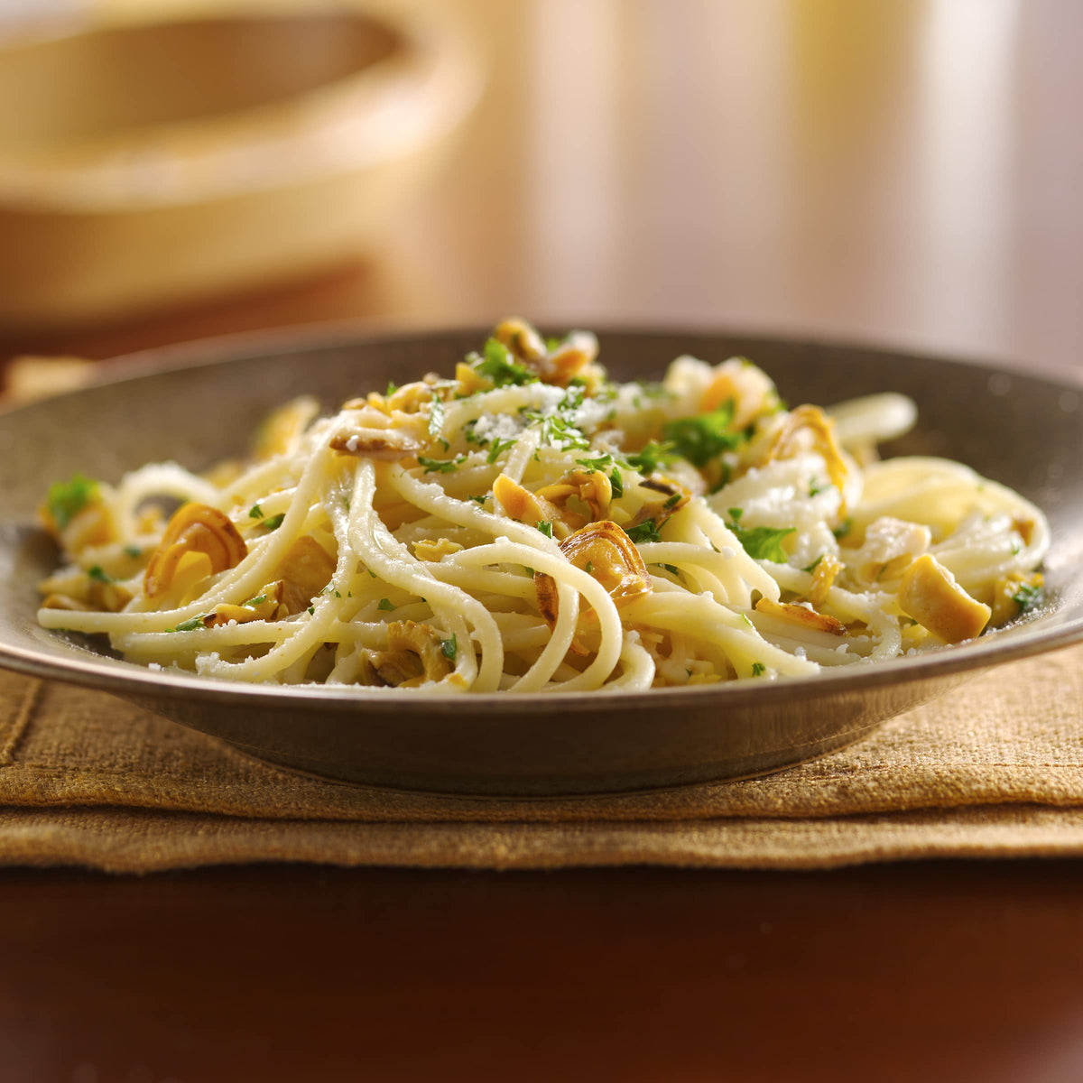 The Progresso White Clam Sauce jar closeup highlighting tender clams and garlic