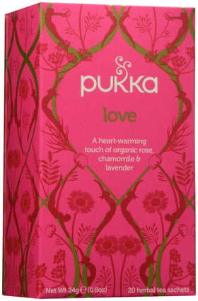 Pukka Love tea bag resting in a mug, inviting a soothing floral ritual.