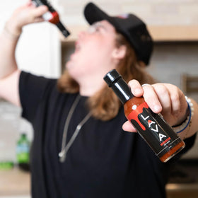 PUP AND THE PEPPER Lava Sauce on tacos for vibrant flavor.
