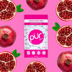 PUR Gum Pomegranate Mint pieces spilled from the bag highlight fruity flavor