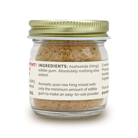 Hing Ever asafoetida powder jar close-up in glass packaging.