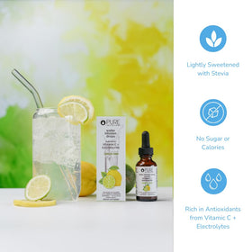 Glass of water with Pure Inventions Lemon Lime drops for electrolyte hydration.