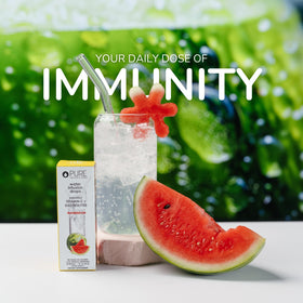 Glass of water receiving watermelon flavor drops from Pure Inventions for hydration boost
